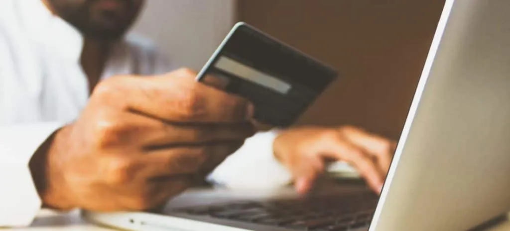 An image of someone paying with a credit card on a computer