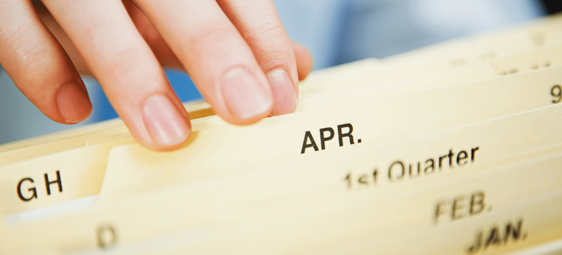 Records Management Challenges Employee filing paper documents in folders