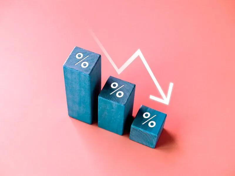 Falling down arrow with percentage icon on blue wood blocks Falling down arrow with percentage icon on blue wood blocks