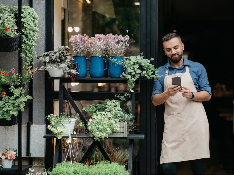 Small business owner checking his phone