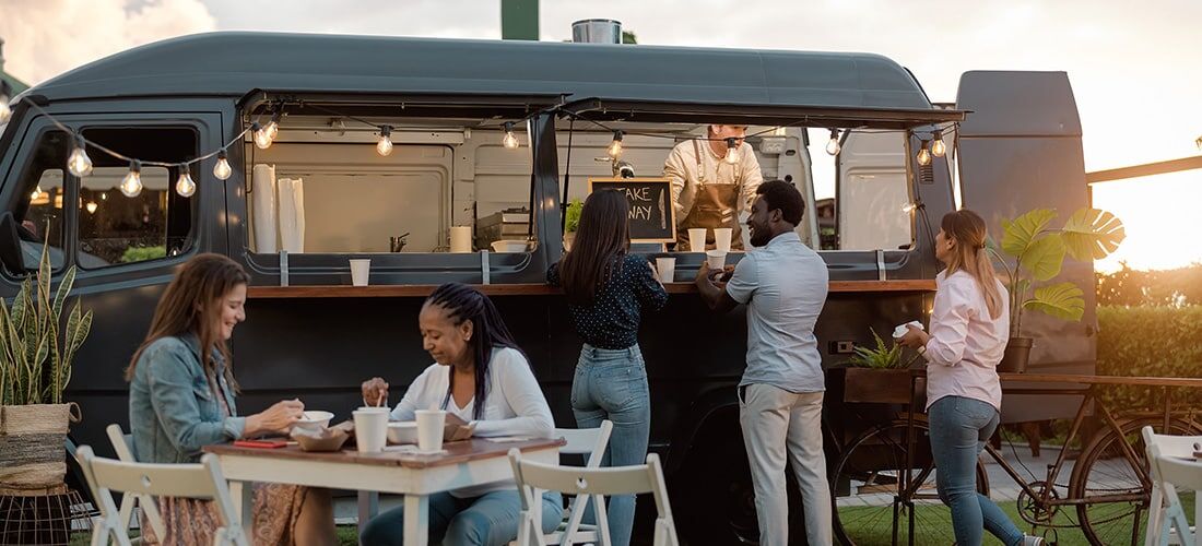 Licensed Food Truck Vendor Happy people eating and buying food from a licensed food truck vendor