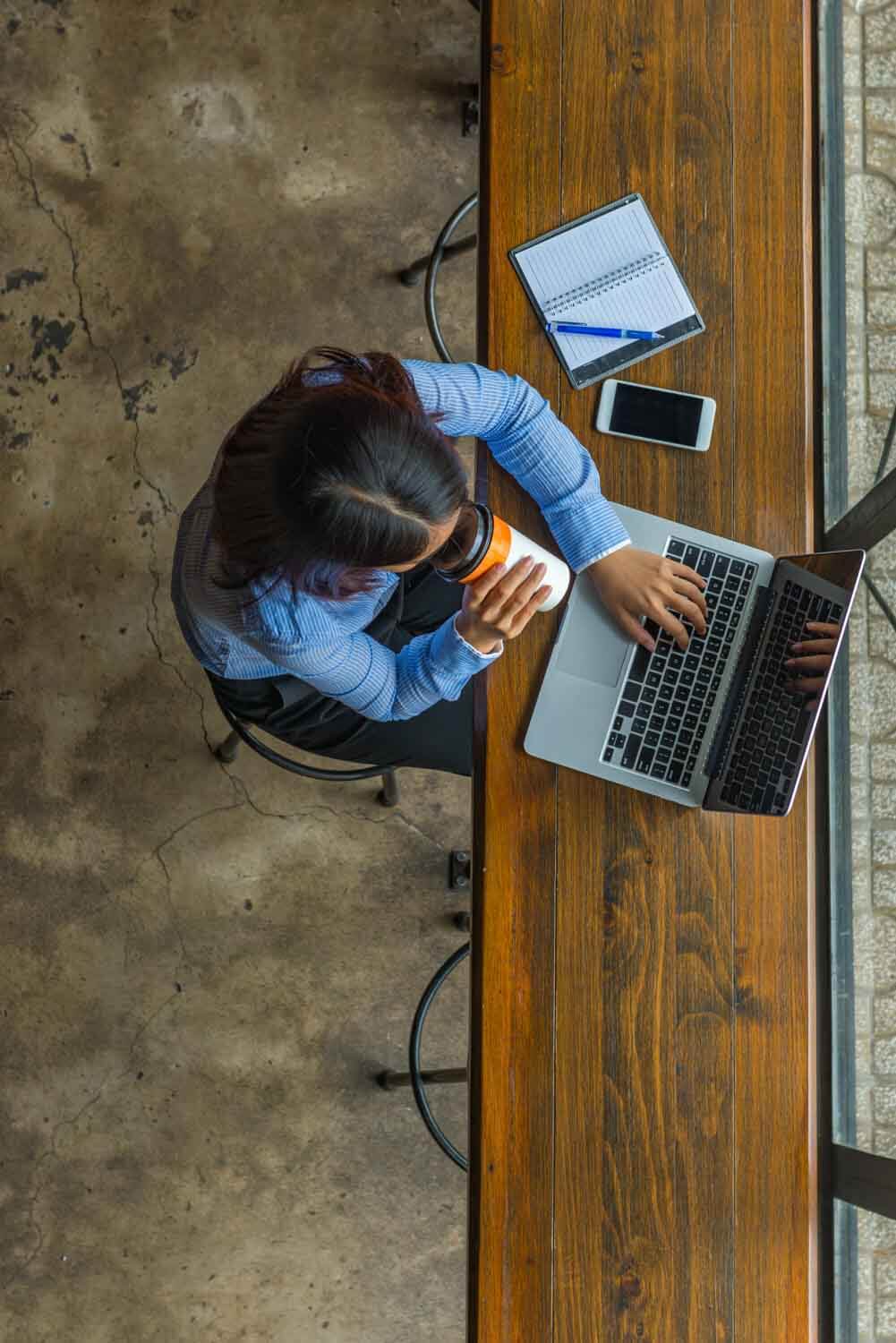 Top down view of a person working on their laptop
