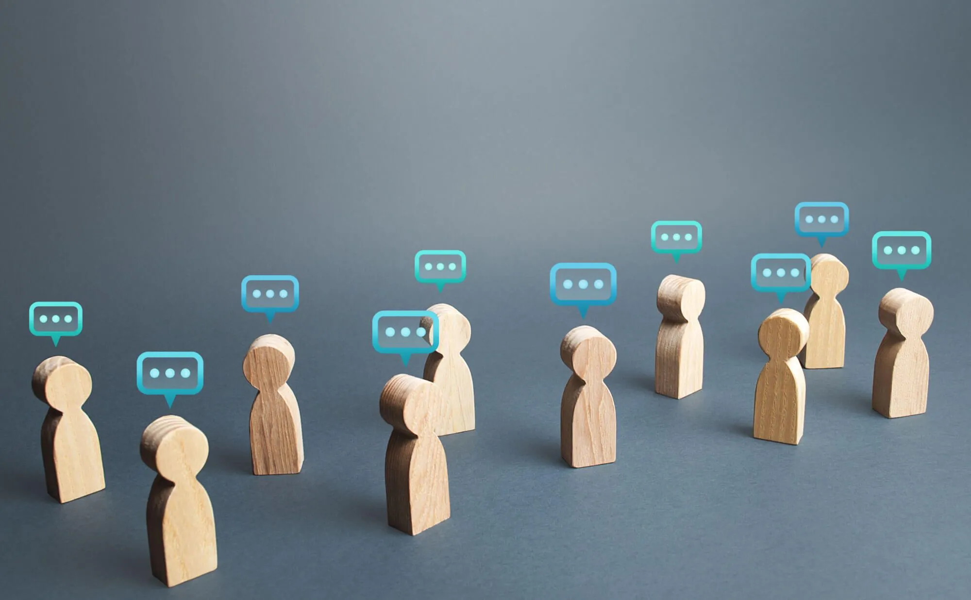 Wooden figures with quote bubbles
