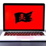 An image of a laptop computer with a pirate flag.