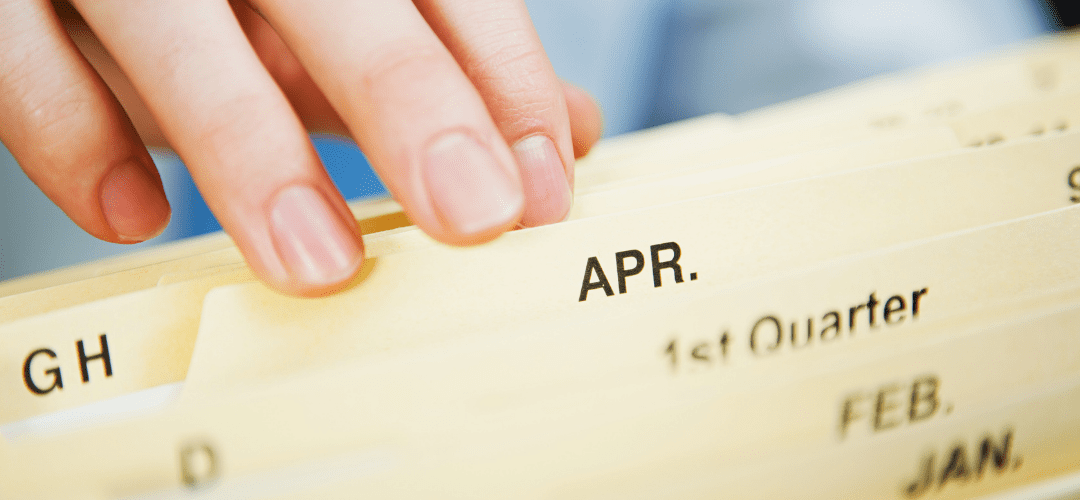 Employee filing paper documents in folders
