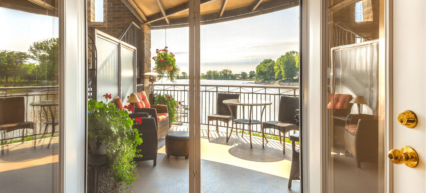 A-view-of-a-lake-and-balcony-through-patio-doors