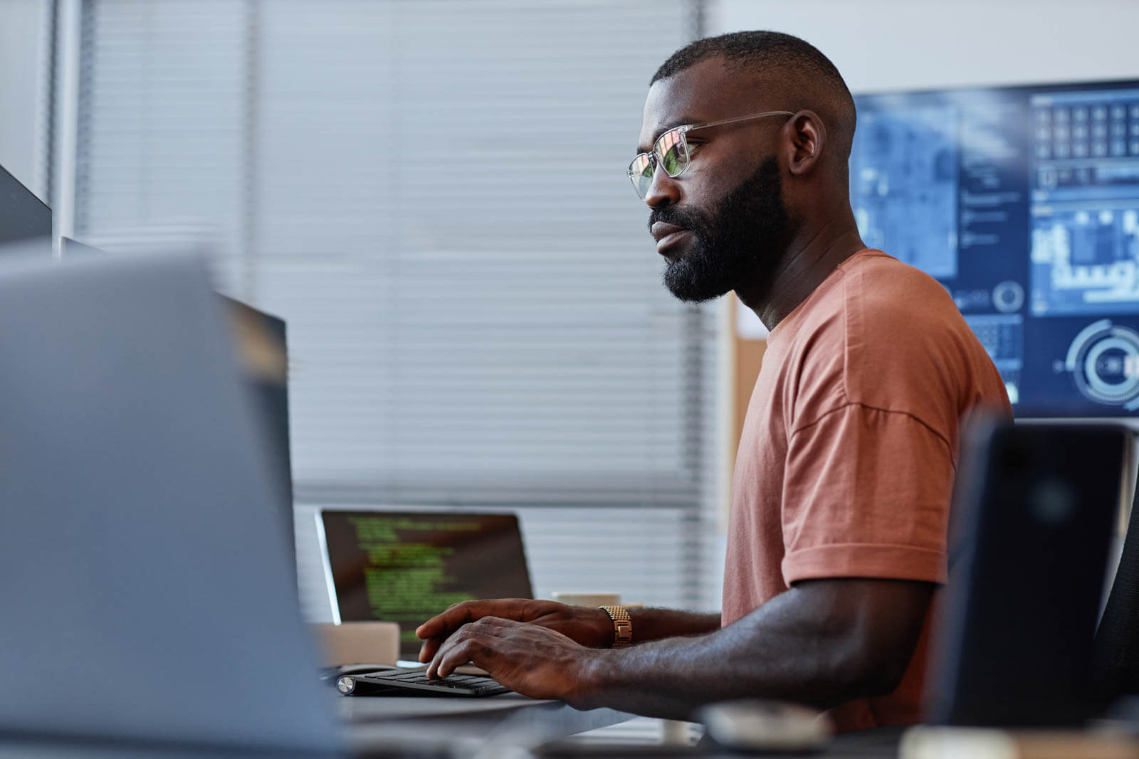 Developer on a computer reviewing analytics