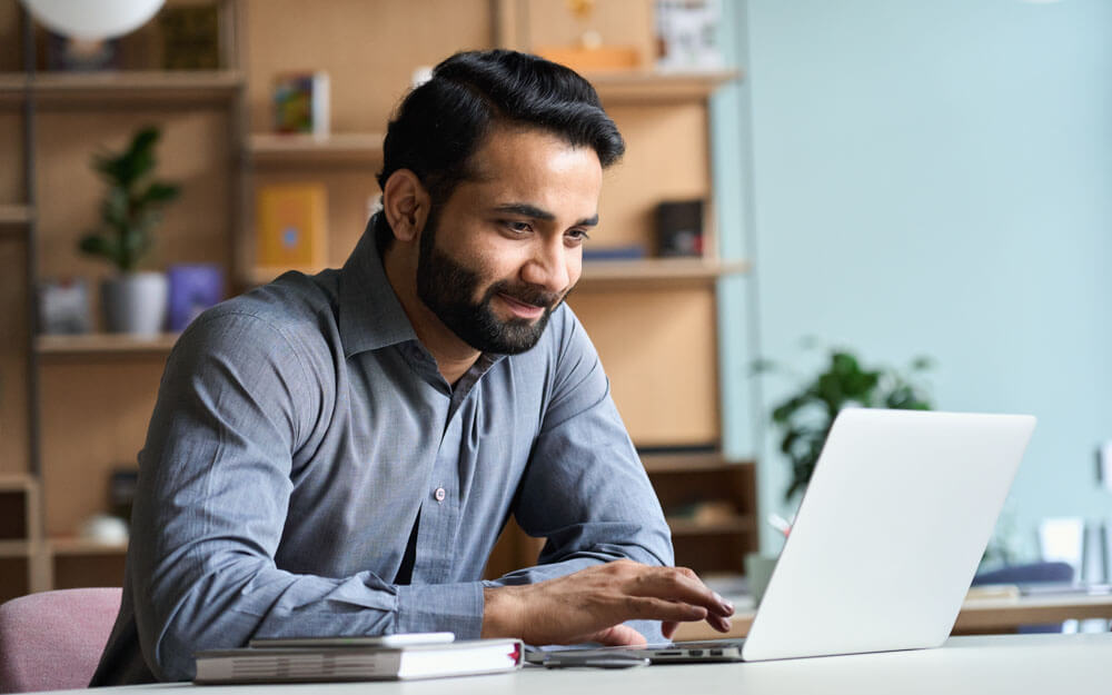 Person working on a laptop in an office