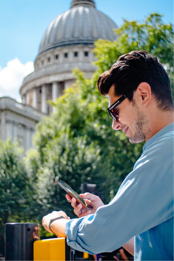 Person in front of government building on phone