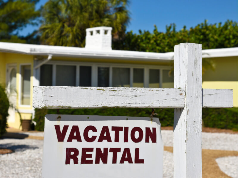 Vacation rental sign in front of a house